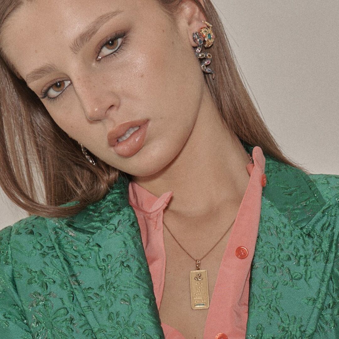 Gold Good Times Tablet over a green brocade jacket